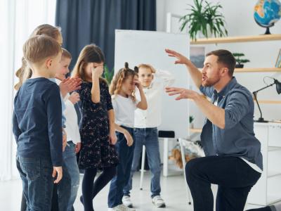 Erzieher erzählt eine Märchengeschichte Kitakinder schauen gespannt