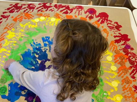 Kind bastelt einen Regenbogen in der Kita